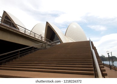 Wide Angle View Of Sails Of Sydney Opera House With Nobody On Stairs, Blue Sky And Clouds As Background.