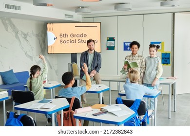 Wide Angle View Of School Classroom With Diverse Group Of Children In 6th Grade Social Studies