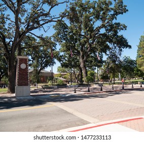 A Wide Angle View Of A Small Town Square Park.