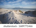 Wide angle view of Table Mountain, one of the natural seven wonders of the world, as seen from Blouberg Beach in Cape Town South Africa
