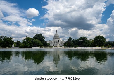 Wide Angle View Of The United States Capitol Building In Washington DC On A Partly Cloudy Summer Day, On The Reflecting Pool