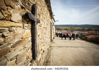 Wide Angle View Of Wooden Cross And Out Of Focus People In Procession