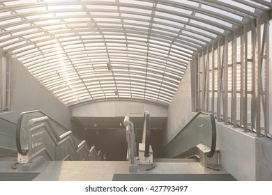 Wide angled view to perspective escalators stairway inside contemporary blue glass business centre, concept of successful career elevation