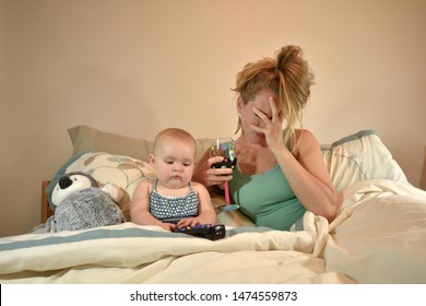 Wide Awake 7 Month Old Baby Girl in Parent's Bed with Tired Frazzled Mother Who Is Drinking A Glass of Wine