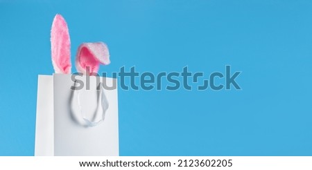 Wide banner on a blue background. The concept of online shopping for Easter