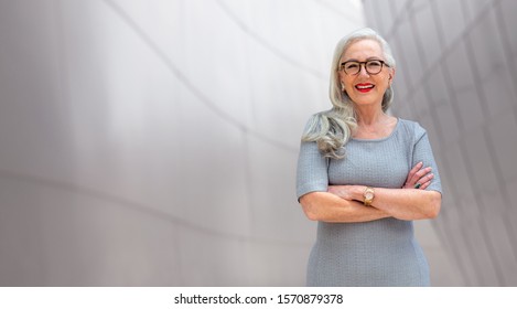 Wide Banner Panorama Portrait Of Elder, Senior, Older CEO Business Woman Standing Confident, Smiling, With Arms Folded, Copy Space