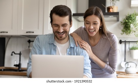 Wide Banner Panorama View Of Smiling Millennial Caucasian Man And Woman Look At Laptop Screen Win Lottery Online. Happy Young Couple Feel Overjoyed Read Good News Or Amazing Discount Deal On Computer.