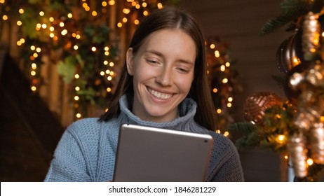 Wide Banner Panoramic Image Of Smiling Millennial Woman Relax On Christmas At Home Communicate Online On Tablet. Happy Young Female Talk Speak On Video Call On Pad Device. Technology Concept.