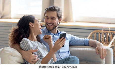 Wide banner panoramic view of overjoyed millennial couple celebrate online win on cellphone together. Happy young Caucasian man and woman triumph with good sale deal or promotion discount on cell. - Shutterstock ID 1877190898