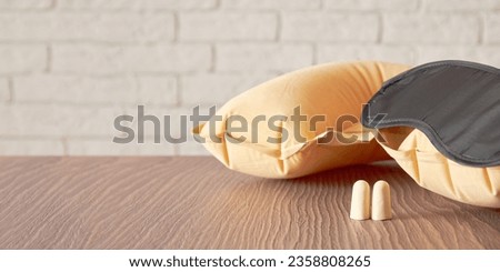 Wide banner with a set of sleeping equipment including mask, pillow and earplugs. Good and healthy sleep concept template with a copy space