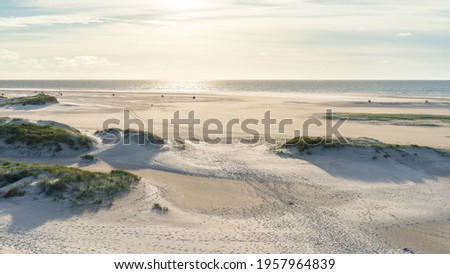 Wide beach by the North Sea in the evening light 