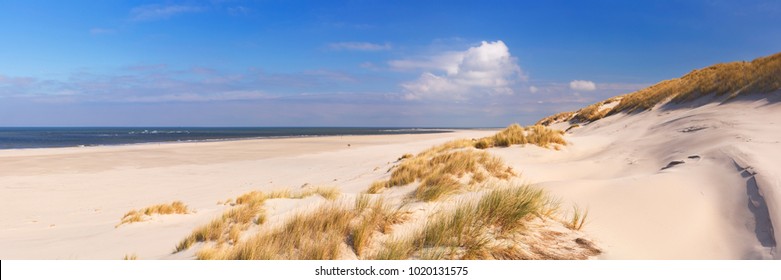 Wide beaches and sand dunes on the Dutch island of Terschelling on a sunny day.