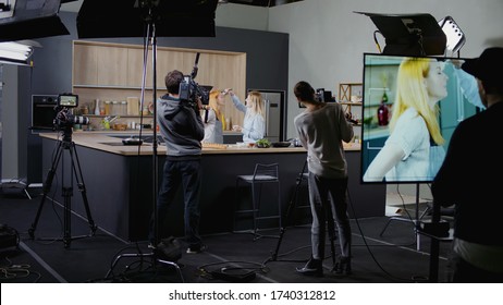 WIDE Behind The Scenes Of Studio Set, Makeup Artist Make Corrections During Shooting Television Cooking Show Featuring Female Chef, Professional TV Production