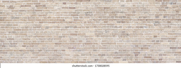 Wide Beige brick wall panoramic background or texture.