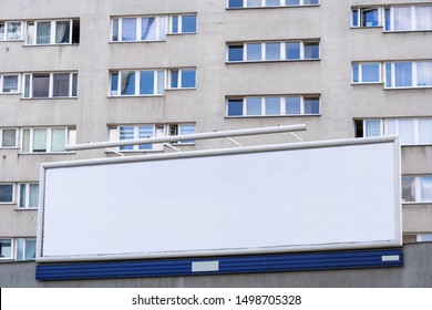 Wide Blank Billboard Against Block Of Flats Condominium In The City.