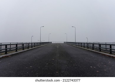 Wide bridge with railings and street lamps. Bridge to nowhere. Perspective into the distance