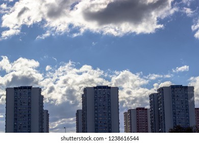 Wide clear shoot of array of concrete buildings with blue sky background