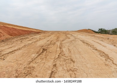 Wide Dry Cracked Dirt Uphill Road Perspective View