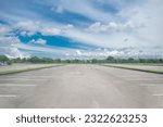 Wide empty asphalt parking lot background. with many cars parked background. outdoor empty space parking lot with trees and cloudy sky. outside parking lot in a park
