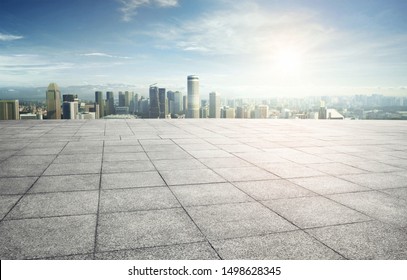Wide empty concrete square floor with  cityscape view.