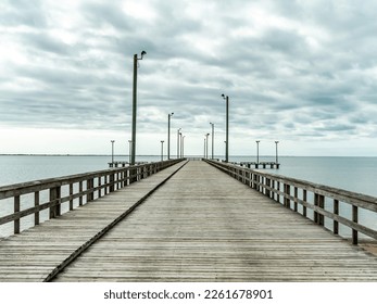 A wide empty pier with street lights in Texas