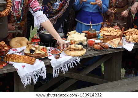 Wide feast with appetizing pancakes, a house pie and fragrant cheese cakes with jam and red both black caviar and a copper big samovar