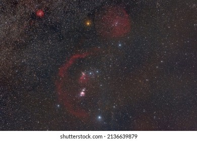 wide field of constellation of Orion with Orion Nebula, flame nebula, barnard's loop and horse head emission nebula on the starry night sky