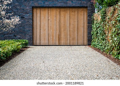 Wide Garage Door And Concrete Driveway In Front 