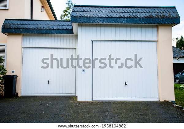 wide garage\
door and concrete driveway in front\
