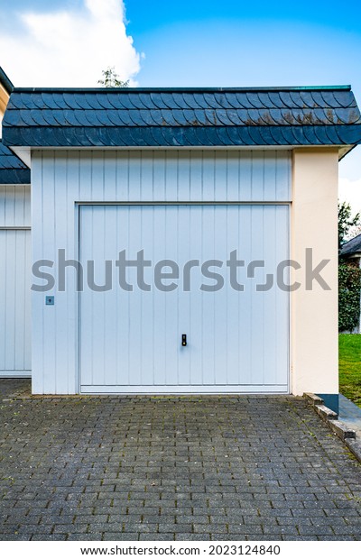 wide garage
door and concrete driveway in front
