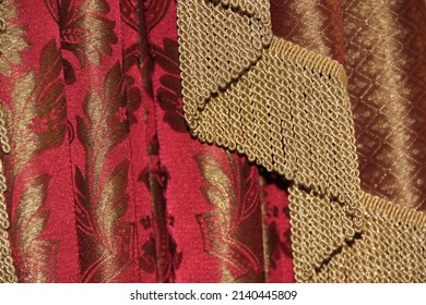 A Wide Gold Fringe On A Red Curtain. Backgrounds