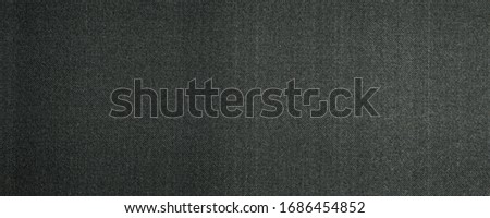 wide grunge dark grey dotted halftone pattern printed on paper useful as a background