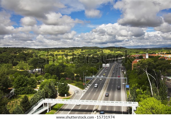 The wide highway crossing\
Madrid