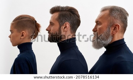 Wide image side face view of three generations of men in row isolated on white studio background. Little boy child with young Caucasian father and old grandfather show offspring descendant line.