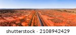 Wide landscape of red soil outback near Broken hill in Australia over railway road track and Barrier highway.