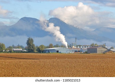 Wide, Landscape View Of Mixed Land Use Including Industrial And Agricultural In A Valley Setting. 