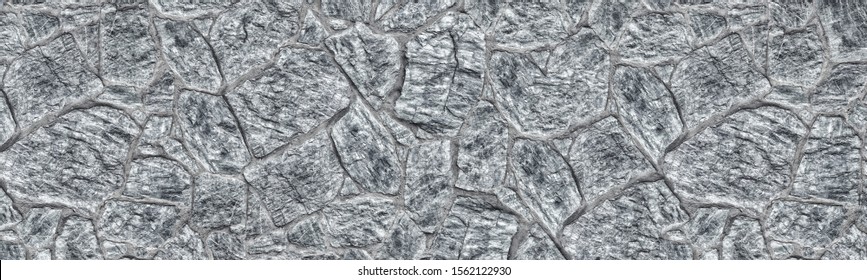 Wide light gray stone wall texture. Shabby granite rock masonry panorama. Large stonework background