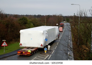 Wide Load Being Escorted On A Main Road In The UK