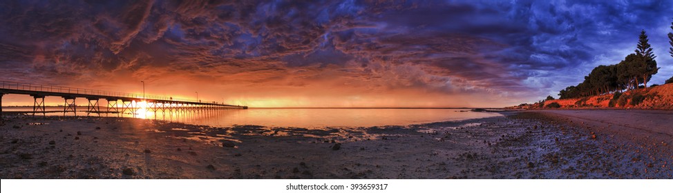 Wide low point panorama of Ceduna bay during distant thunderstorm at sunset. Great Australian bight at low tide from wooden jetty to town coast. - Powered by Shutterstock