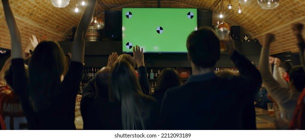 WIDE Model Released, Fans Watching A Game On A Large TV In A Sport Pub, Celebrating A Goal, Green Screen Chroma Key