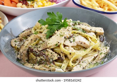 Wide Noodles With Chicken, Truffle Mushroom, Butter, And Cream Sauce In Plate