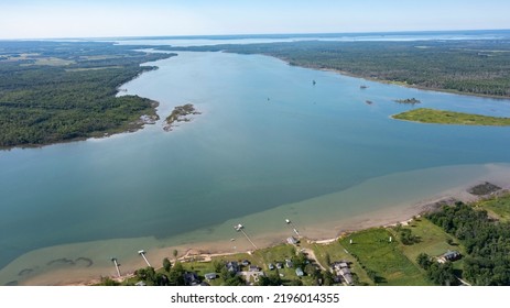 Wide open channel. Aerial drone view of St. Mary's River between Lake Superior and Lake Huron with water channels passing through landscapes between Canada and The Unites States of America. - Shutterstock ID 2196014355