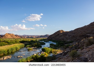 Wide Open Landscape With A River And Mountains