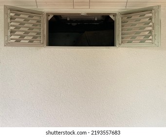 Wide Open Window Sashes With Ventilation Grilles In A White Wall