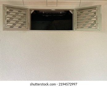 Wide Open Window Sashes With Ventilation Grilles In A White Wall