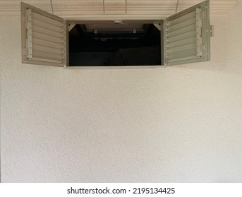 Wide Open Window Sashes With Ventilation Grilles In A White Wall