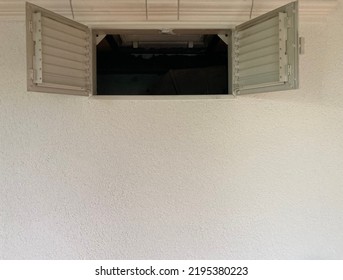 Wide Open Window Sashes With Ventilation Grilles In A White Wall