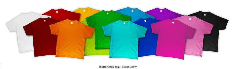 wide panorama banner row of many fresh new fabric cotton t-shirts in colorful rainbow colors isolated. Pile of various colored shirts on white background. diy printing fashion concept.