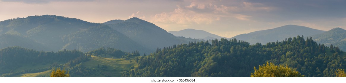 Wide Panorama Of Carpathian Mountain Range In Sunset Light.