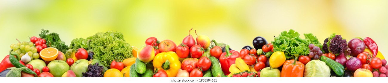 Wide panorama fruits, vegetables, berries for your layout on green blurred background